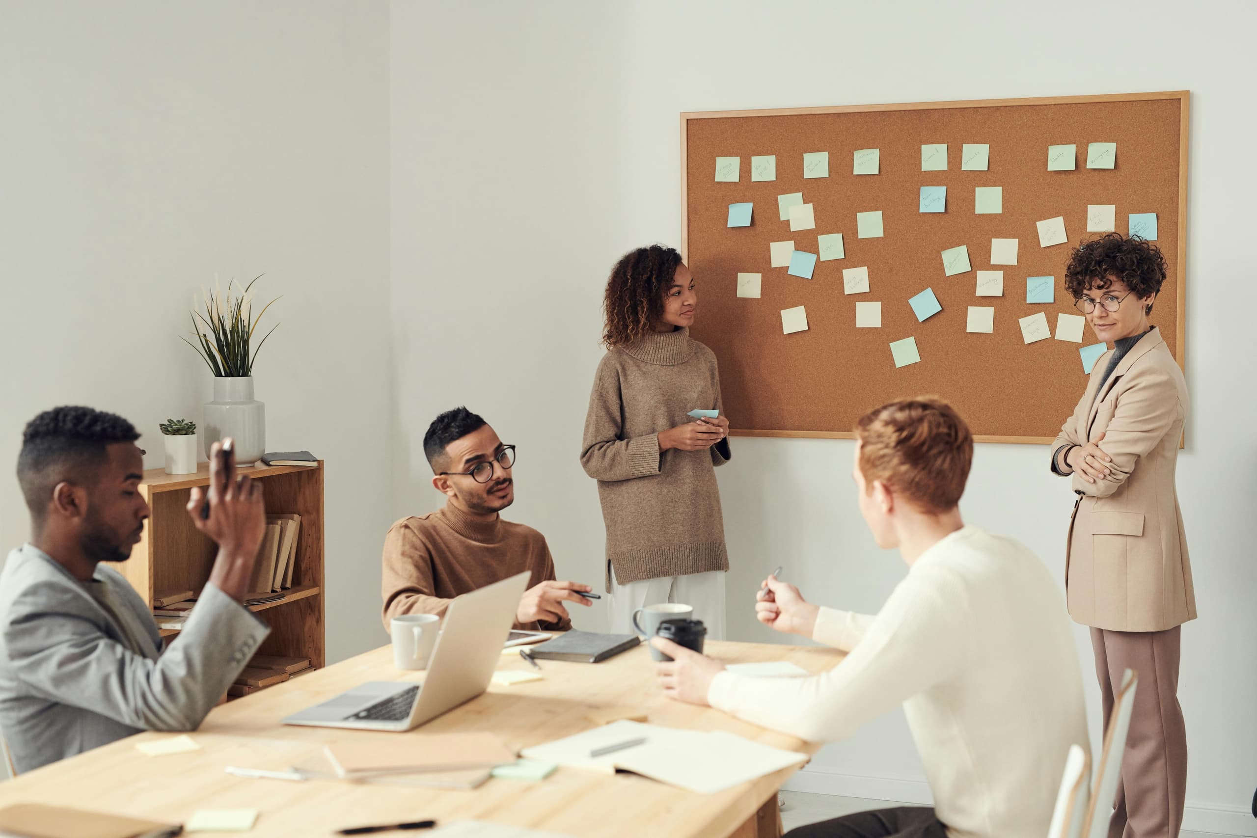 Team collaborating at a table — services and delivery